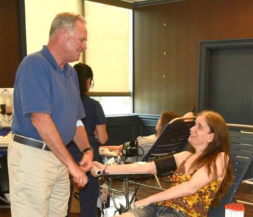 Assemblyman Michael Fitzpatrick (R,C,I-Smithtown), who also gave blood, greets local resident Kristy Conn as she gives a blood donation at his drive in Hauppauge.