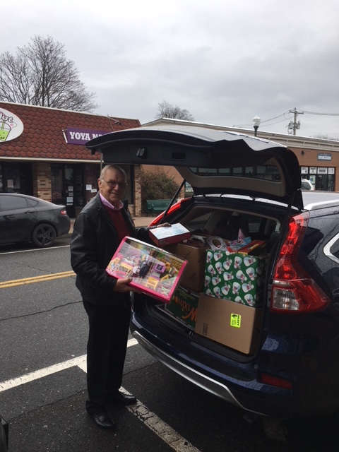 Assemblyman Dave McDonough (R,C,I-Merrick) is seen loading his car with many toy donations on the way to the John Theissen Children's Foundation.