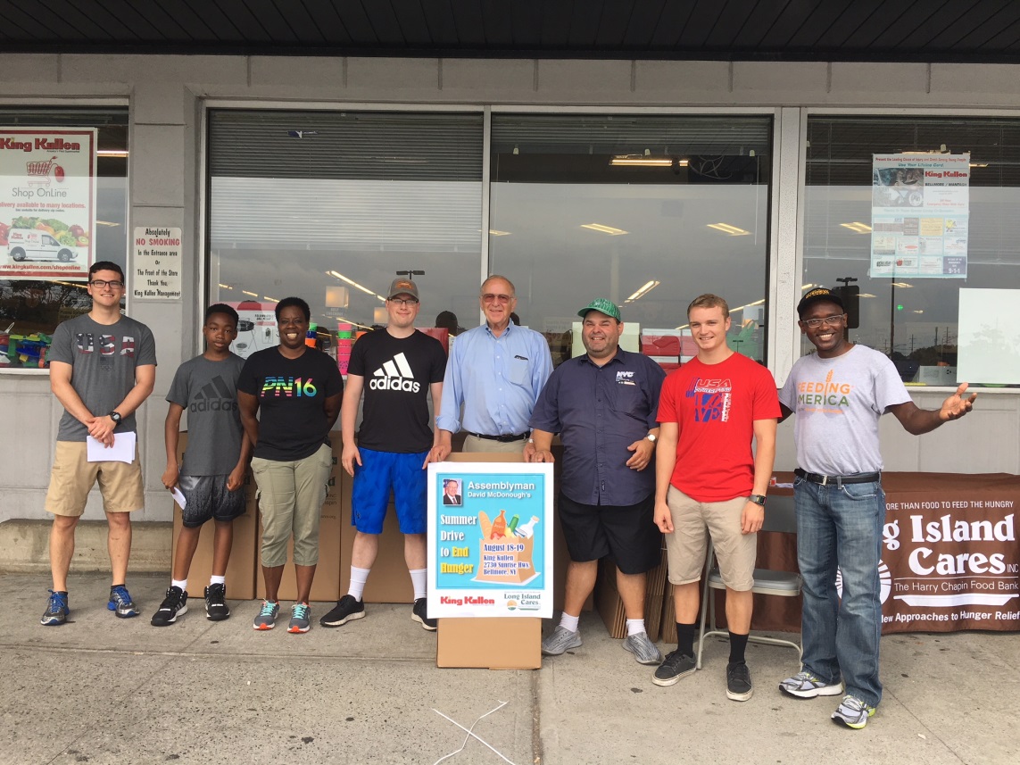 Assemblyman Dave McDonough [center] collects donations for needy families at King Kullen with volunteers from Long Island Cares.