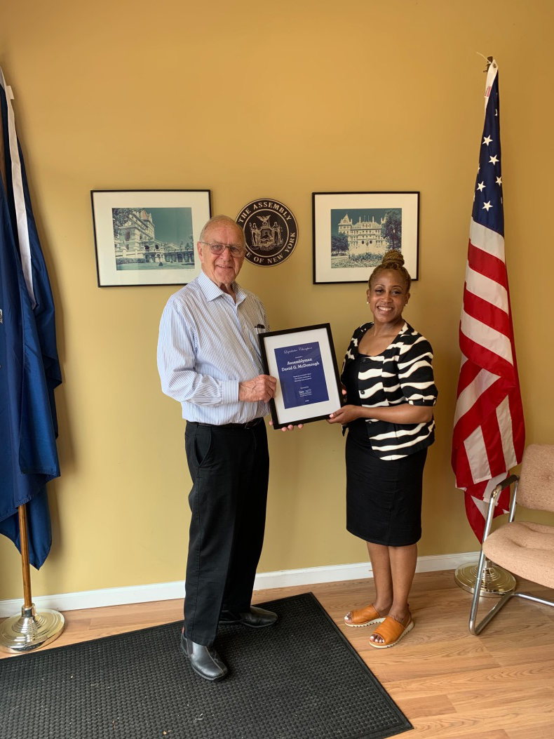 Assemblyman Dave McDonough(R,C,I-Merrick) [pictured left] accepting a plague of recognition from Karen Cummings of LiveOnNY.