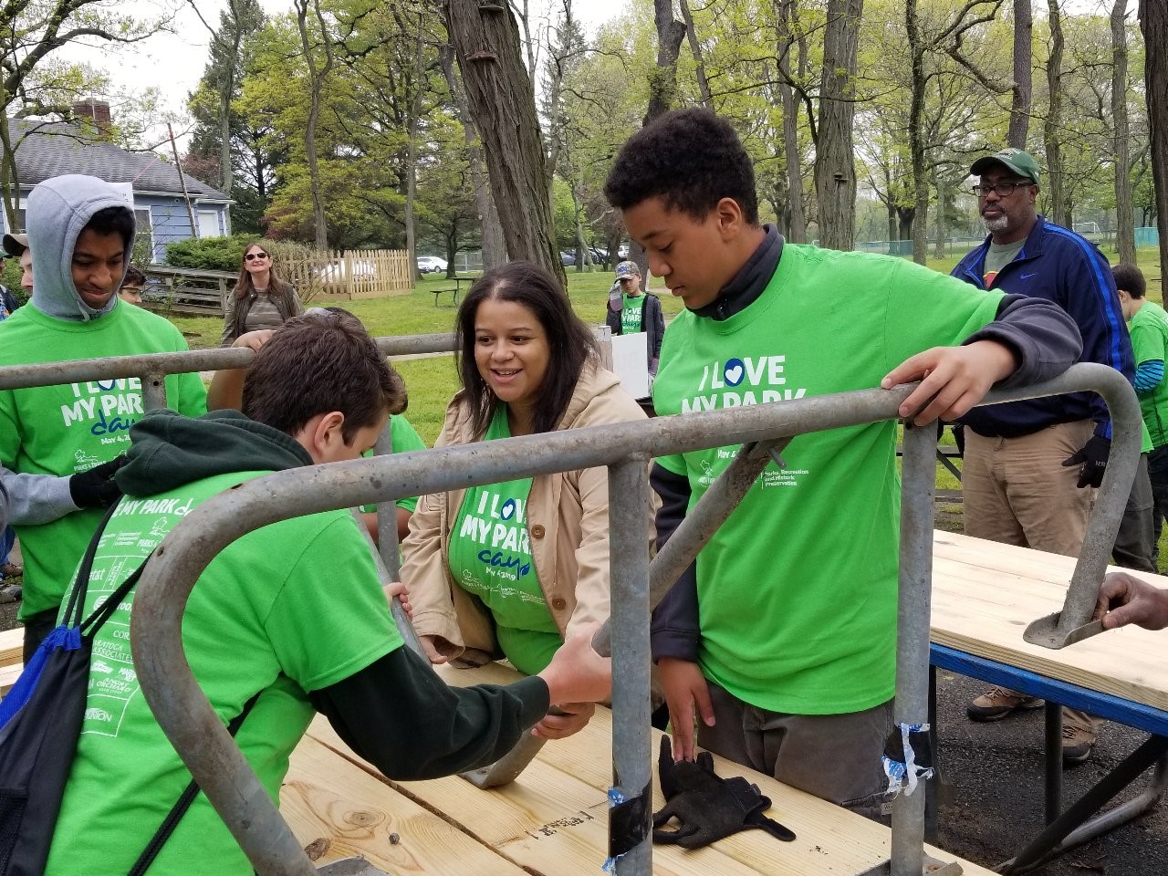 Constituents work with Assemblywoman Solages to build picnic tables at the Valley Stream State Park on I Love My Parks Day.