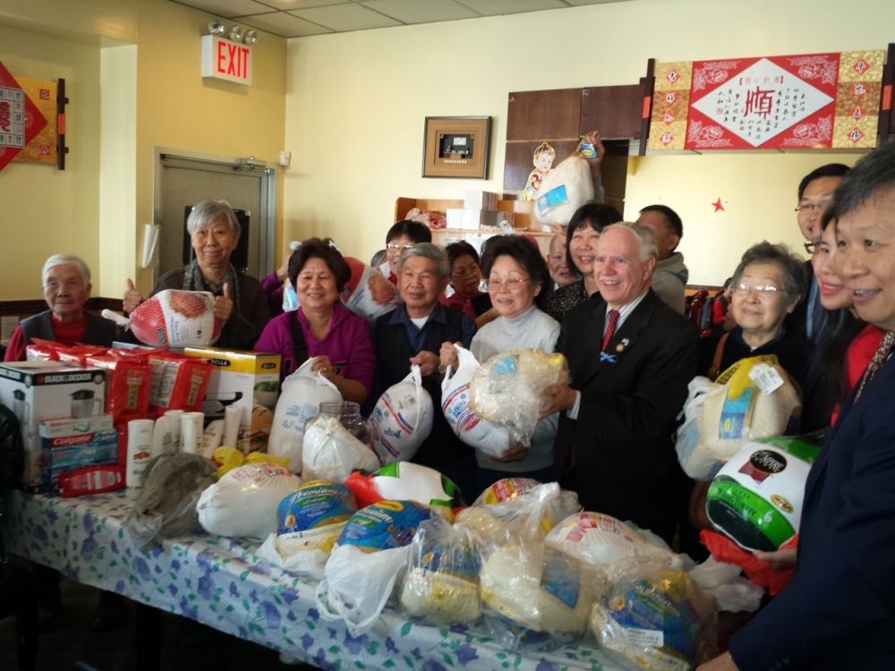 Assemblymember William Colton and Community Relations Director Nancy Tong with Homecrest Community Center Chair, Don Lee, at a turkey give away at the Homecrest Community Service Senior Center.