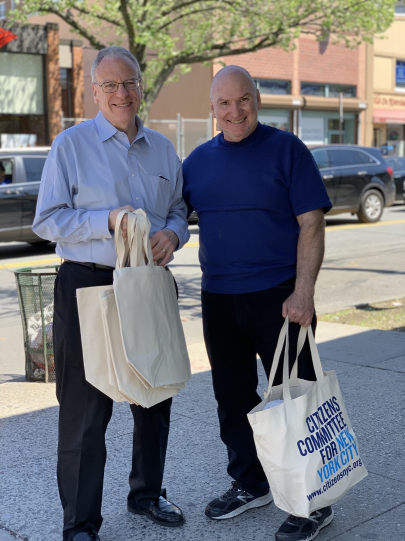 Assemblyman Jeffrey Dinowitz with a neighborhood resident excited to get a free reusable canvas bag from Citizens Committee of New York City along Johnson Avenue.