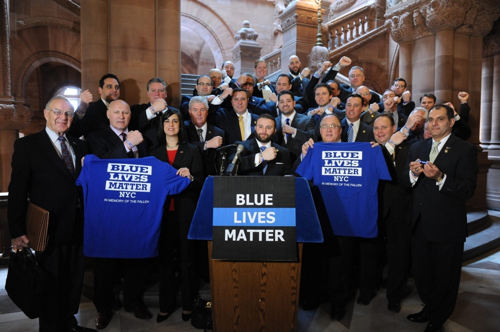 Members of the Assembly Minority Conference and representatives from Blue Lives Matter at a press conference showcasing their Blue Lives Matter wristbands.