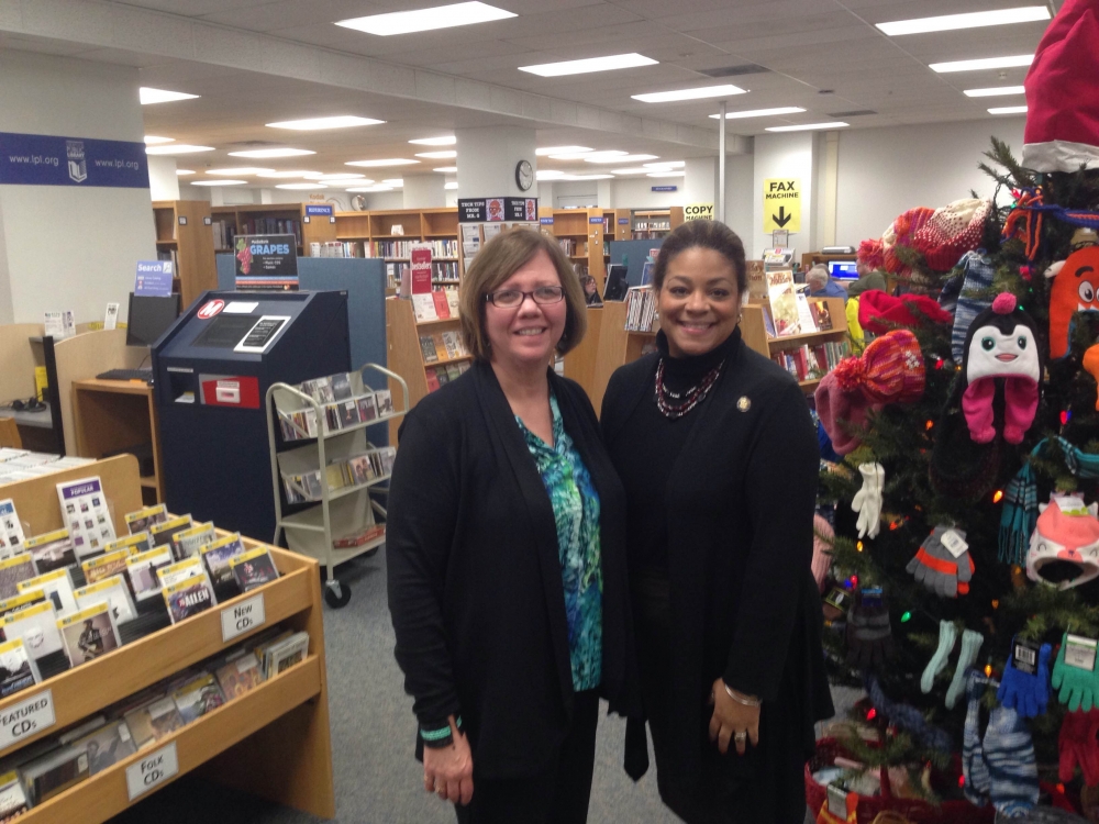 Assemblymember Pamela Hunter and Glenna Wisniewski, director of the Liverpool Library, meet during a stop in Liverpool.