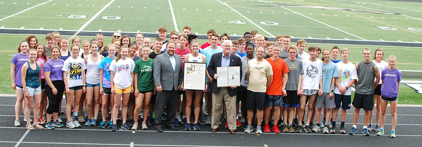 On the track at the Corning-Painted Post High School on Tuesday, May 28, from left to right in the center of the front row, Assemblyman Palmesano, Lindsey Butler, Senator O’Mara, and Head Coach J