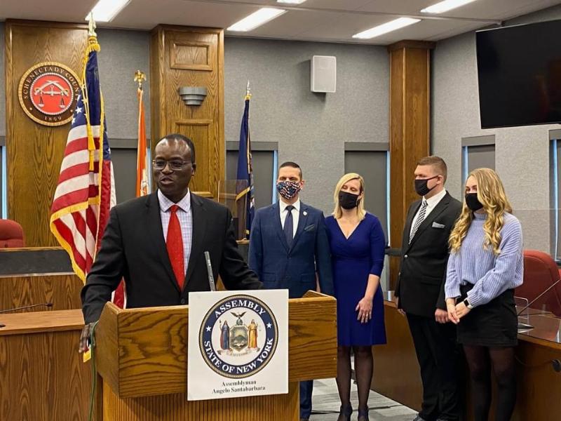 Schenectady County Legislator Philip Fields delivers welcome remarks at Assemblyman Santabarbara’s Swearing-In Ceremony today while Assemblyman & Mrs. Santabarbara, Michael Santabarbara and Marianna Santabarbara look on.